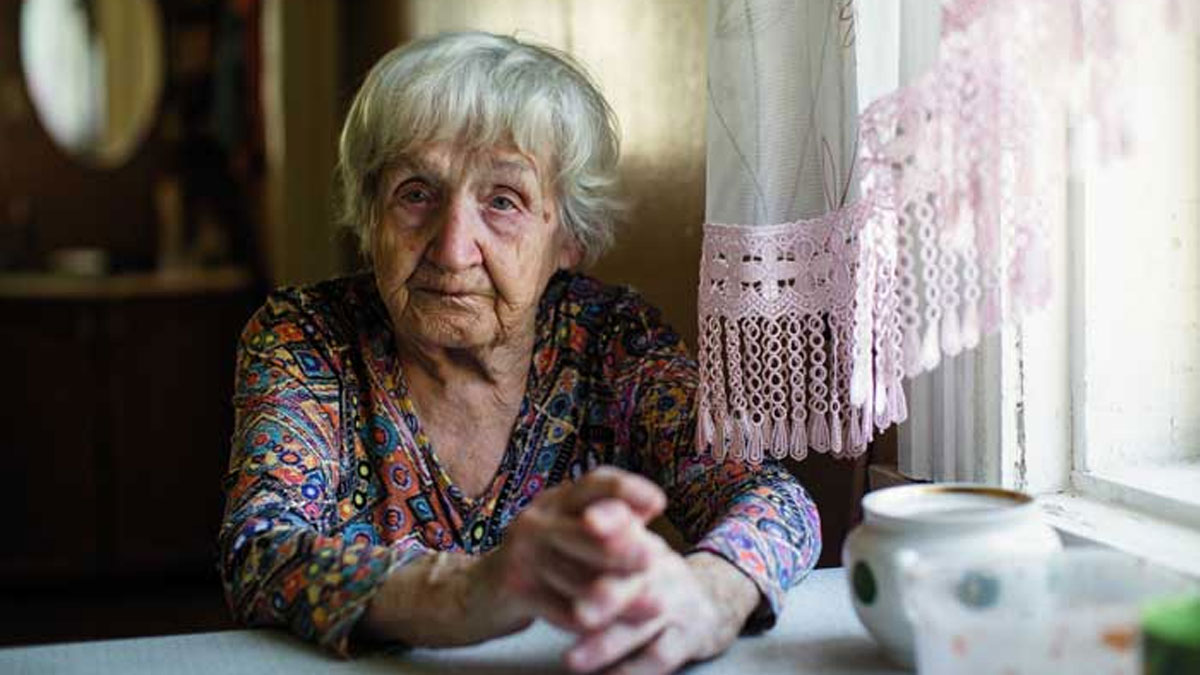 An older woman sits alone